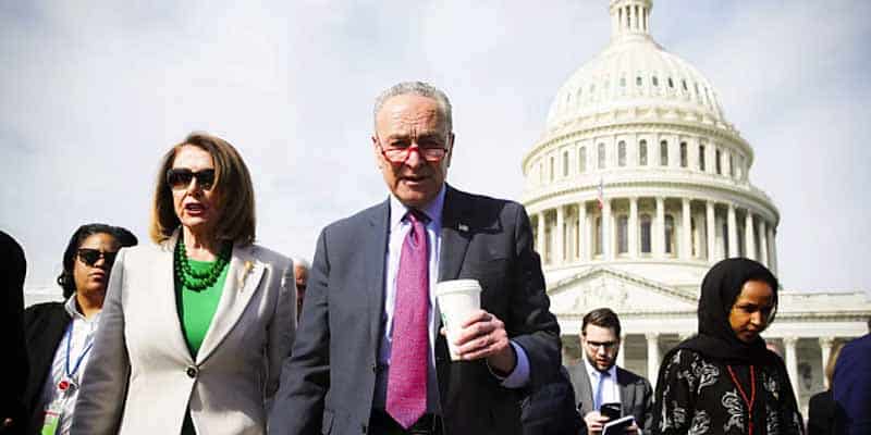 Chuck Shumer Nancy Pelosi and other Democrats walking in front of the US Capitol