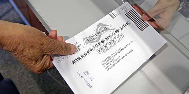 a mail in vote being submitted to the post office