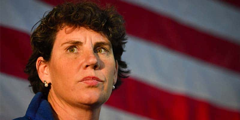 Amy McGrath in front of an American flag