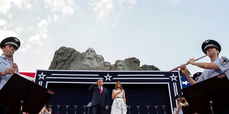 Donald and Melania Trump at a podium in front of Mt. Rushmore