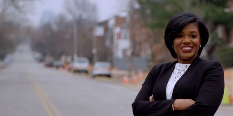 Cori Bush with her arms folded on a city street