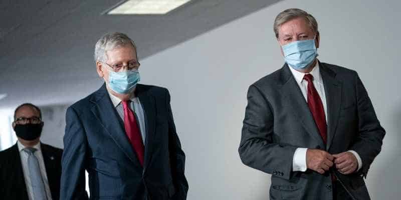 Mitch McConnell and Lindsay Graham walking together with masks on