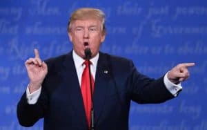 donald trump pointing while standing at microphone